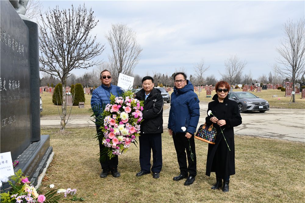 A group of people standing next to a grave

Description automatically generated with low confidence