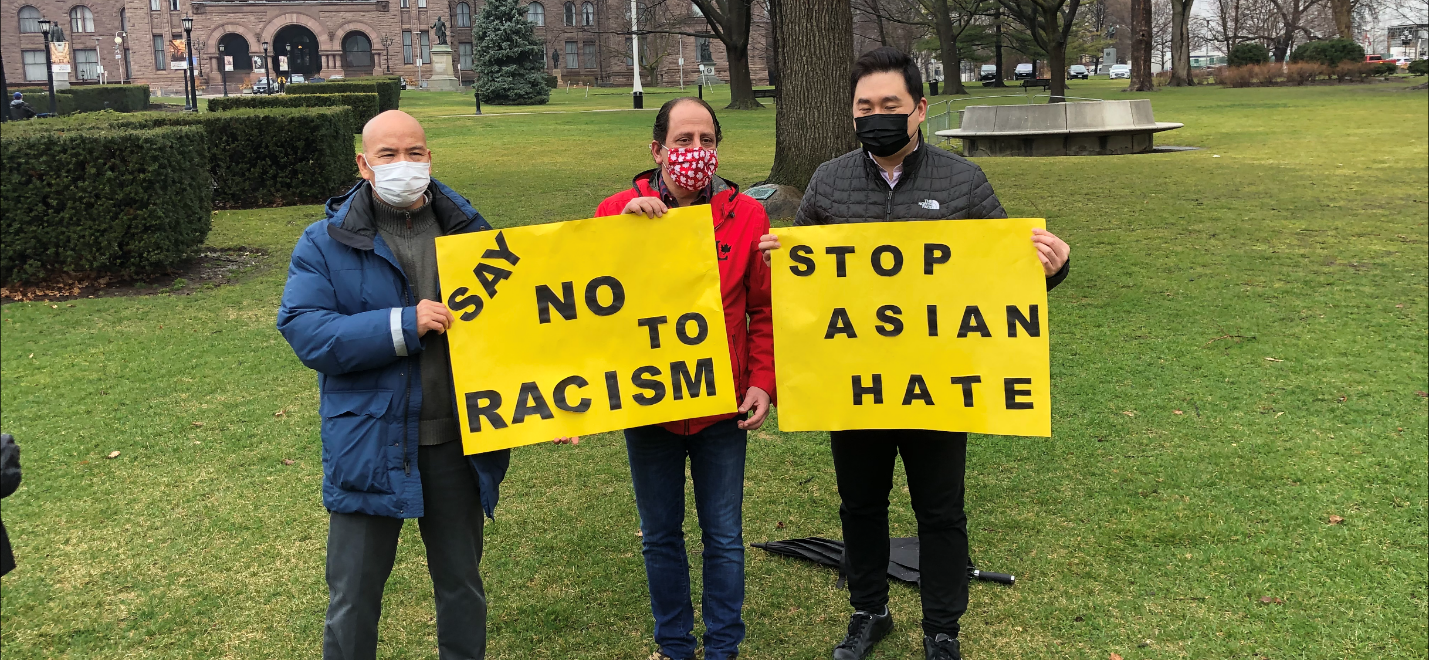 A group of men holding signs

Description automatically generated with medium confidence