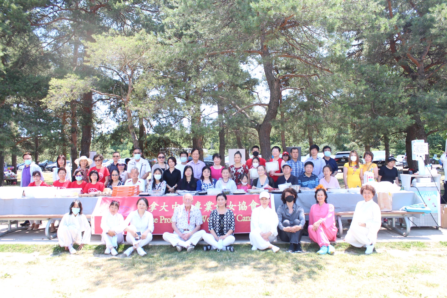 A group of people sitting on a bench Description automatically generated with low confidence