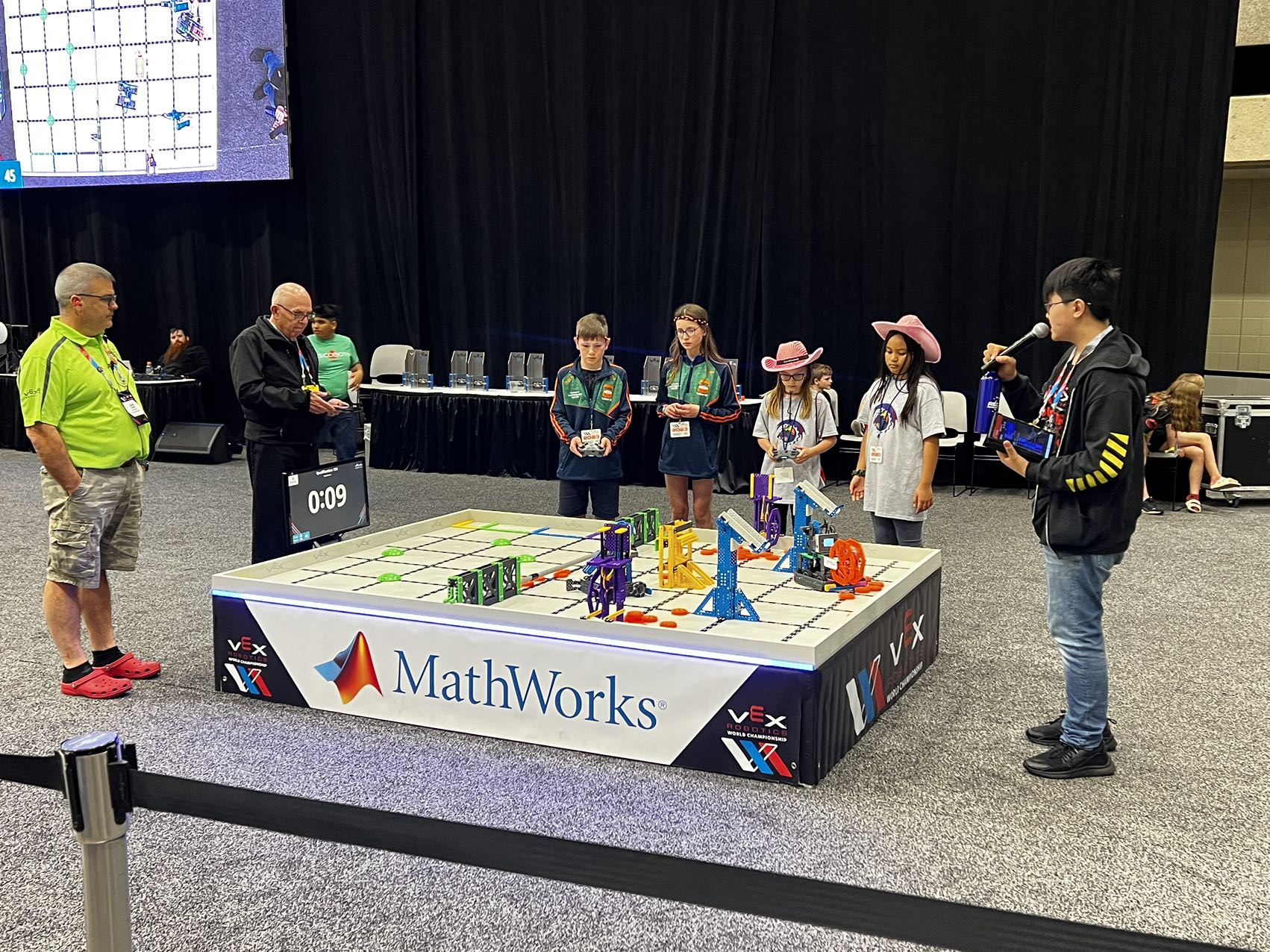 A group of people standing around a table with toys Description automatically generated with low confidence