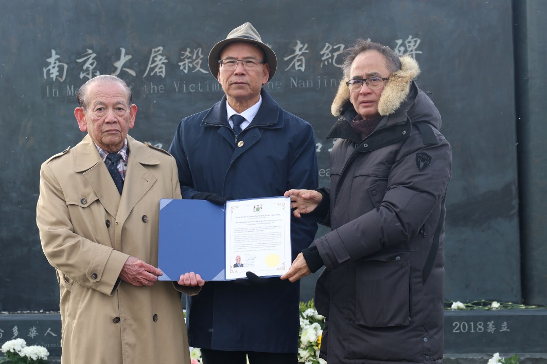 A group of men holding a piece of paper

Description automatically generated