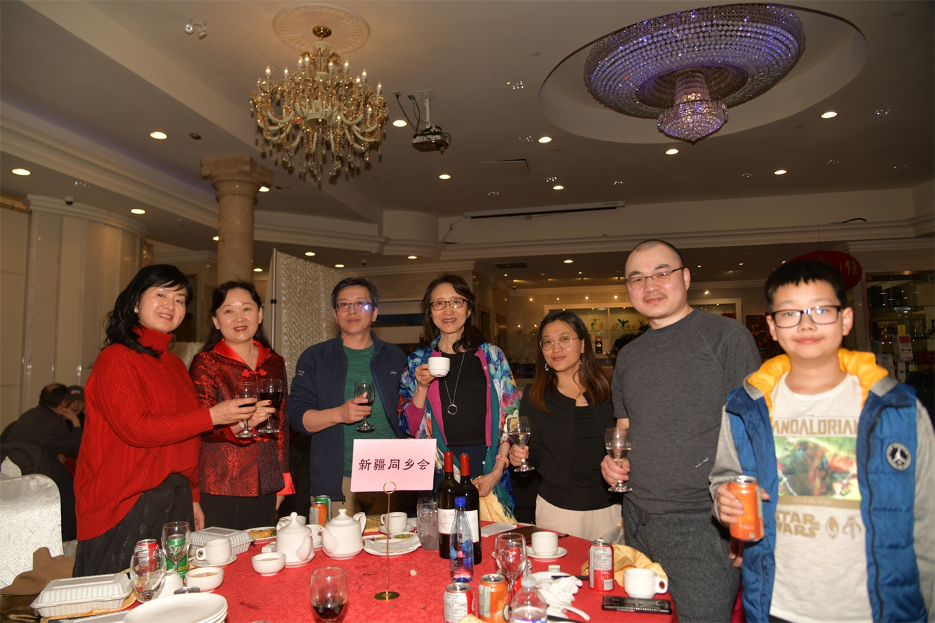 A group of people holding glasses of wine

Description automatically generated