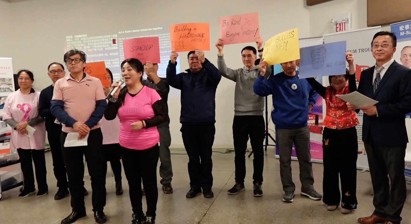 A group of people holding signs

Description automatically generated