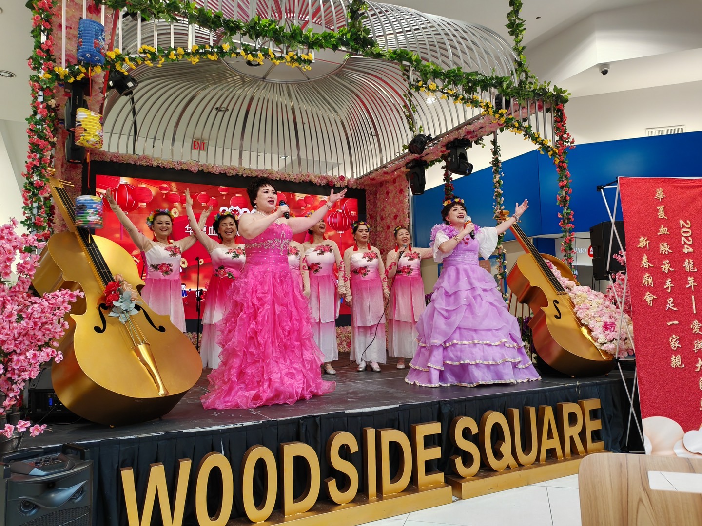 A group of women in dresses on a stage

Description automatically generated