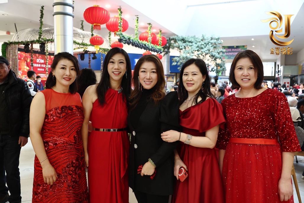 A group of women in red dresses

Description automatically generated