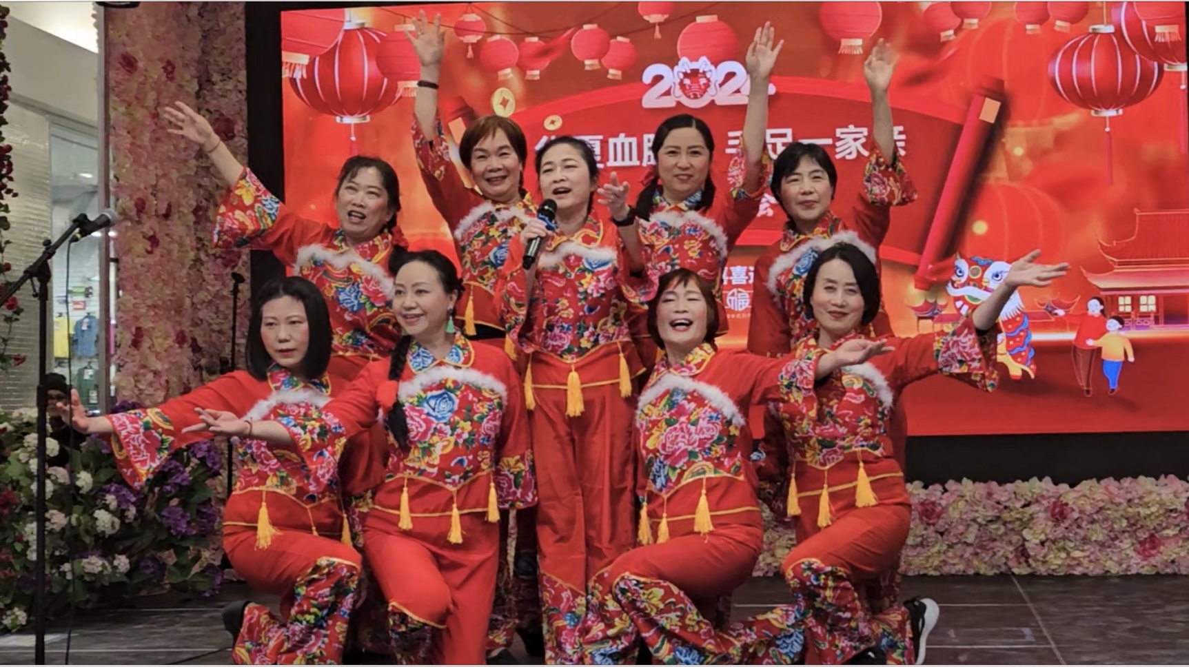 A group of women wearing red and yellow outfits

Description automatically generated