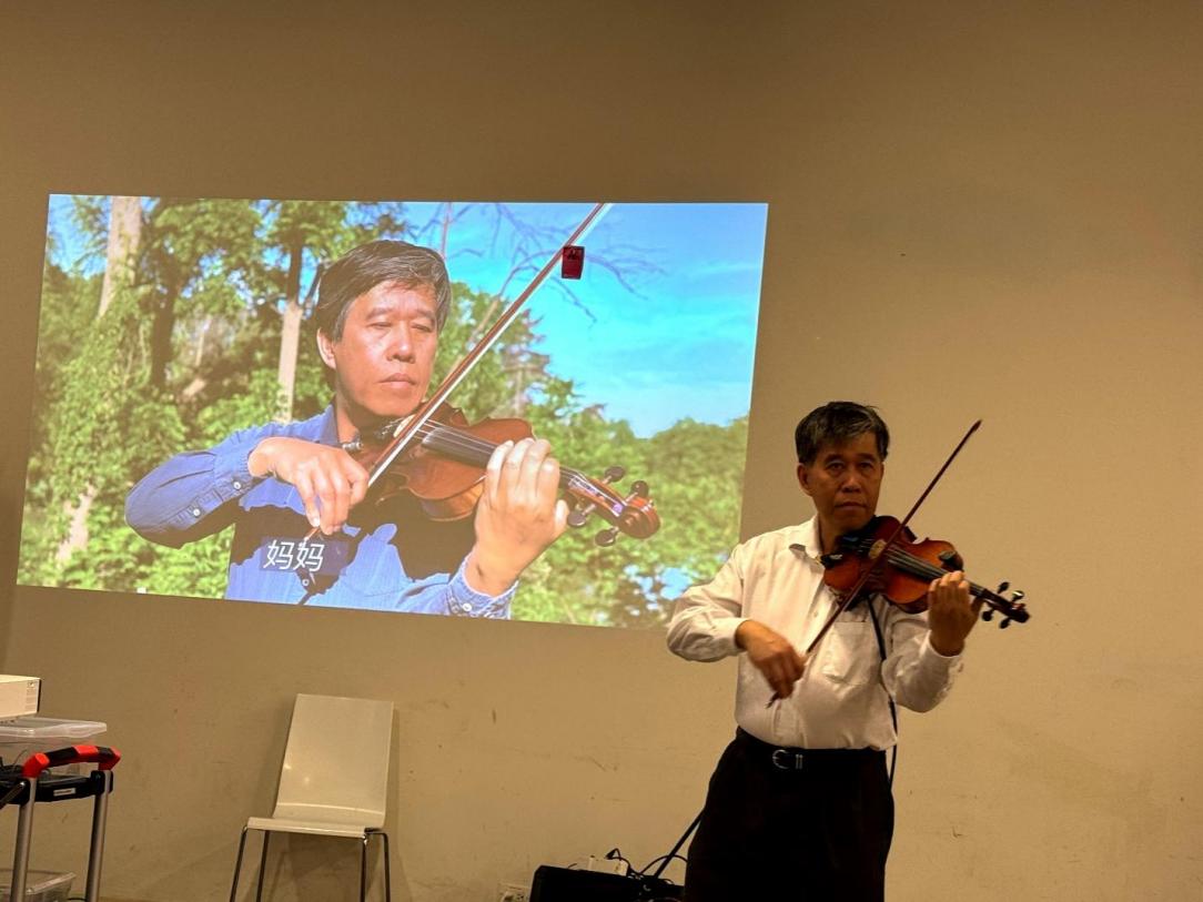 A person playing a violin

Description automatically generated