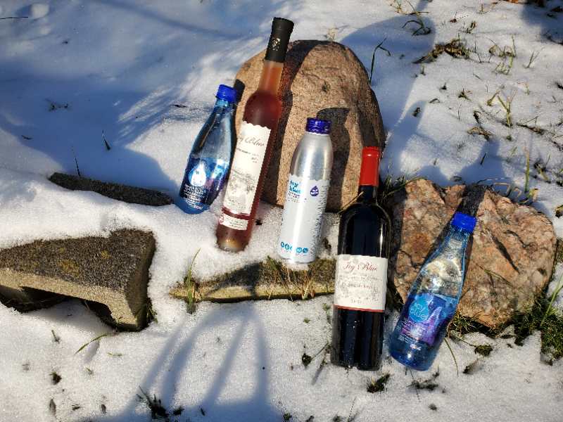 Bottles of liquid and bottles in the snow

Description automatically generated