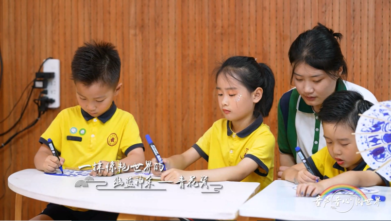 A group of children sitting at a table Description automatically generated