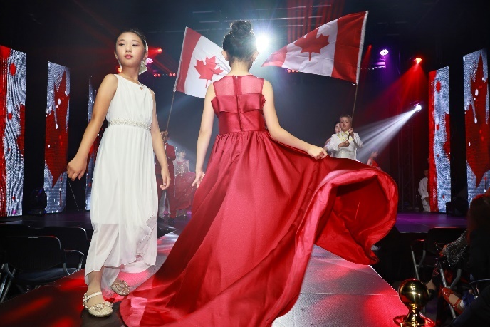 A group of girls walking on a runway Description automatically generated