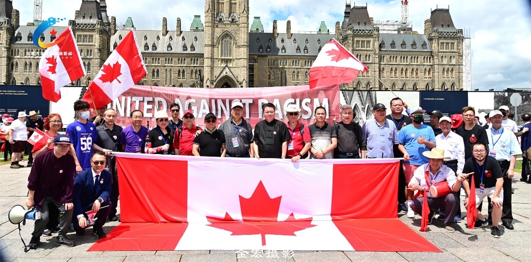 A group of people standing in front of a flag Description automatically generated