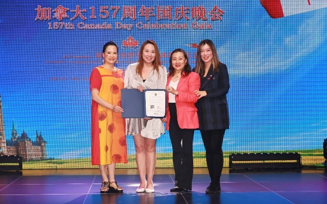 A group of women on a stage Description automatically generated