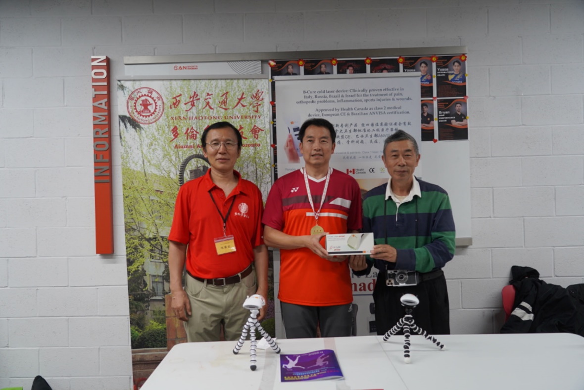 A group of men standing in front of a table Description automatically generated