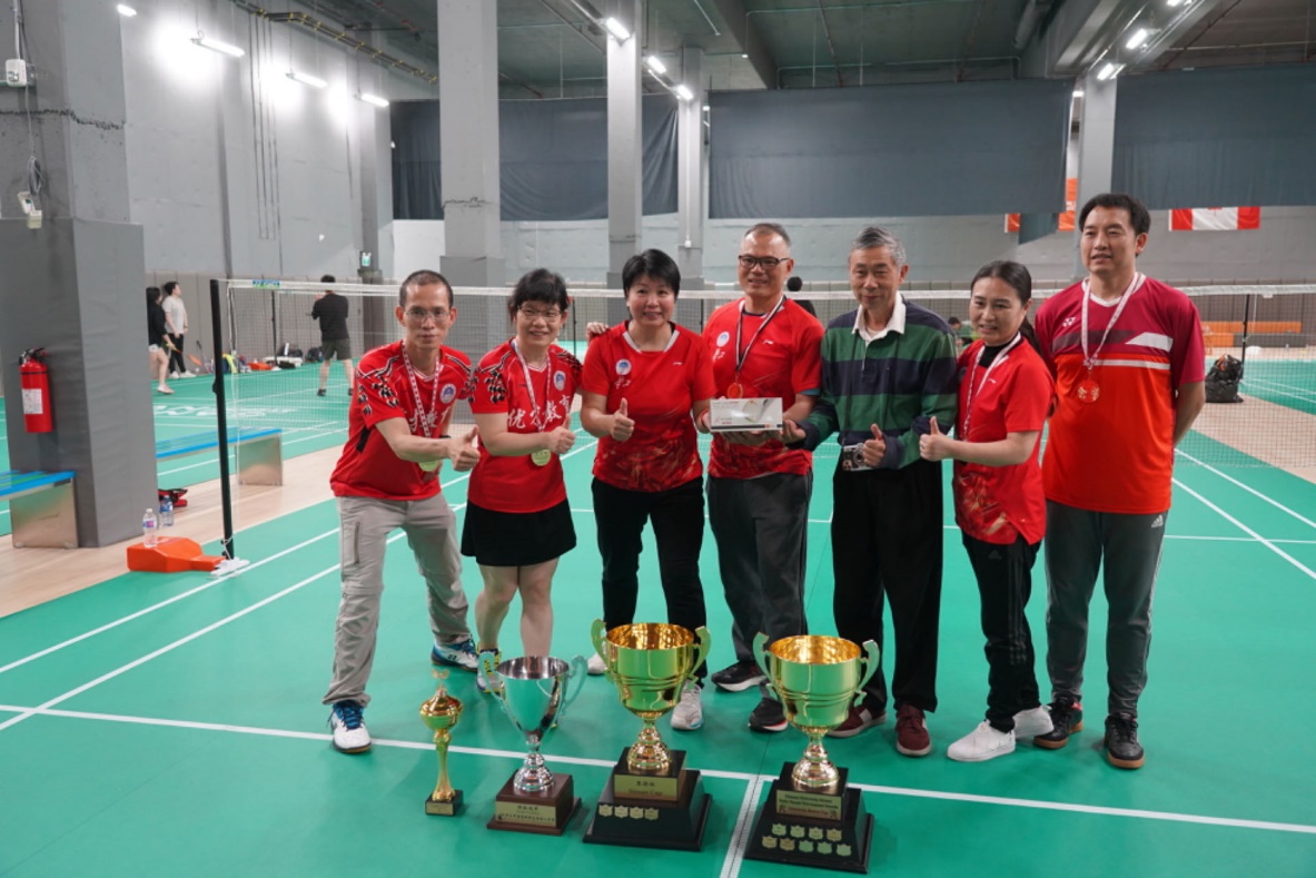 A group of people posing for a photo with trophies Description automatically generated