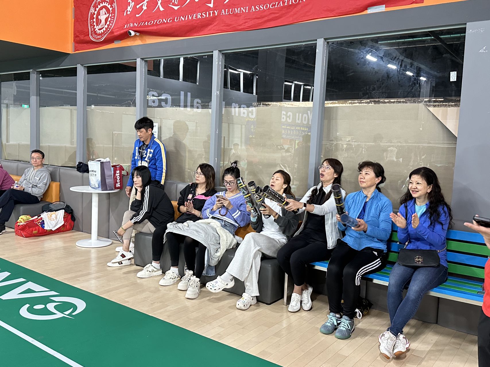 A group of people sitting on benches playing musical instruments

Description automatically generated