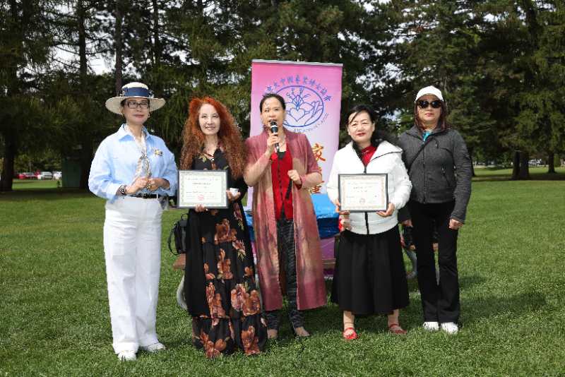 A group of women holding certificates Description automatically generated