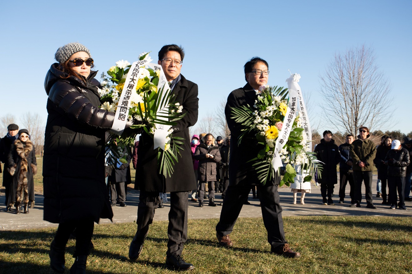 A group of people holding flowers Description automatically generated