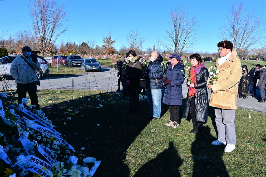 A group of people standing in a field Description automatically generated