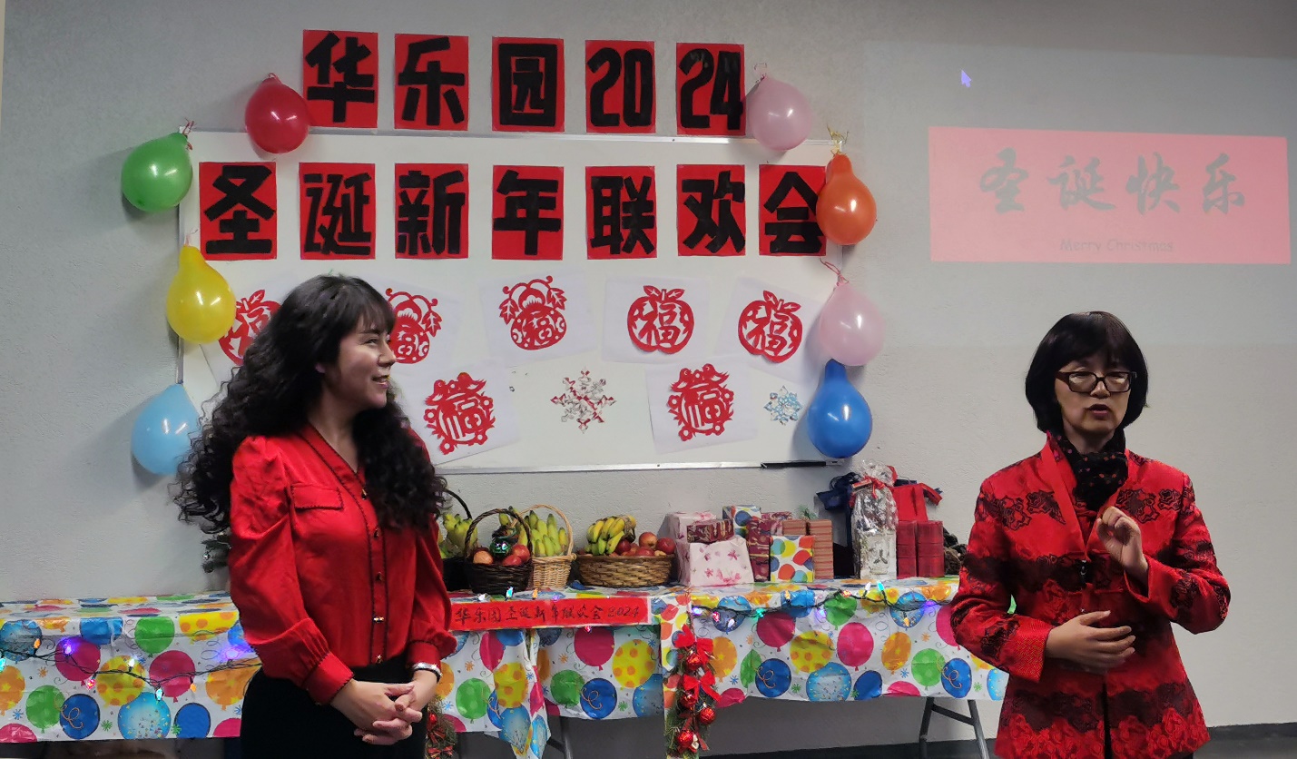 A group of women standing in front of a table

Description automatically generated