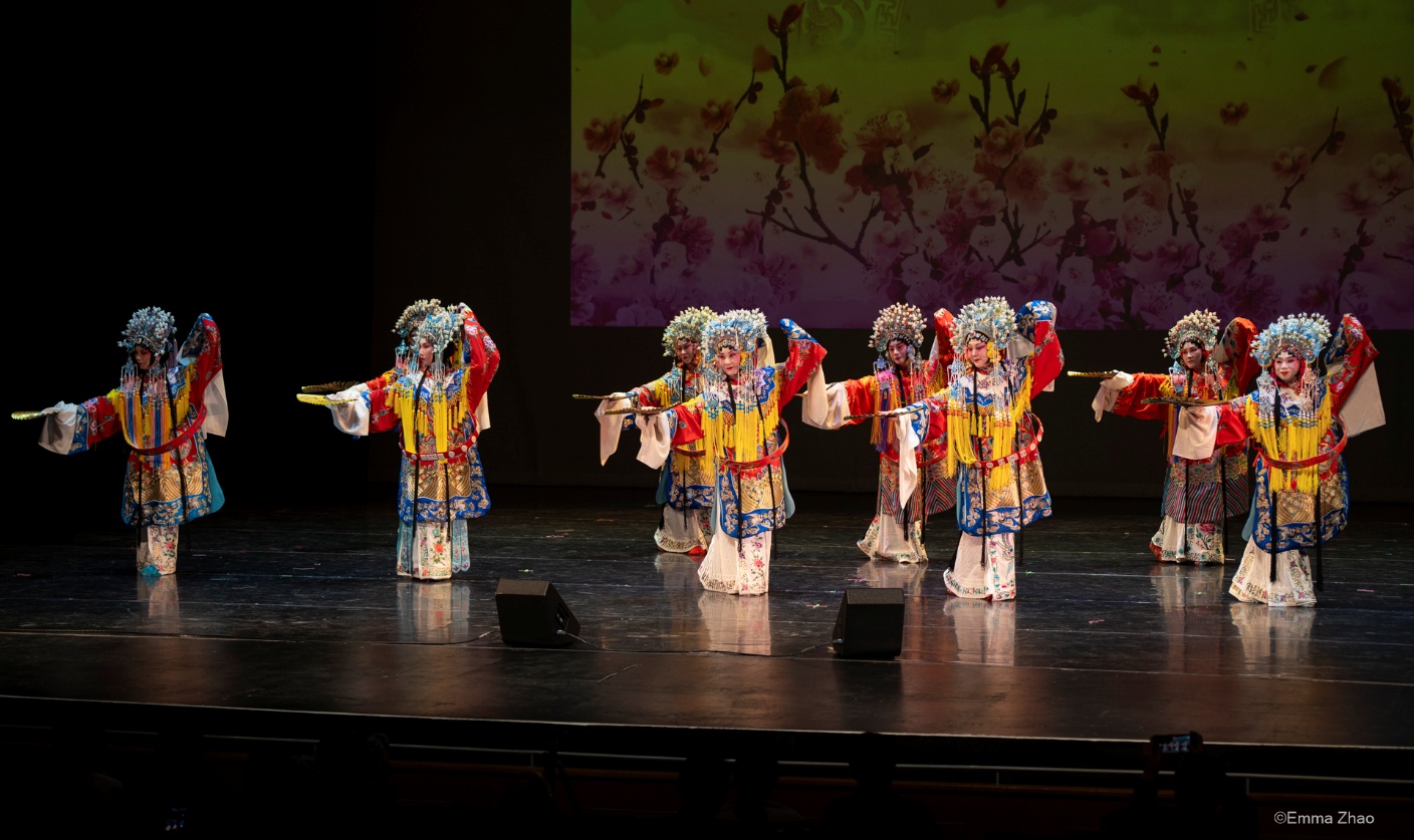 A group of children performing on stage Description automatically generated