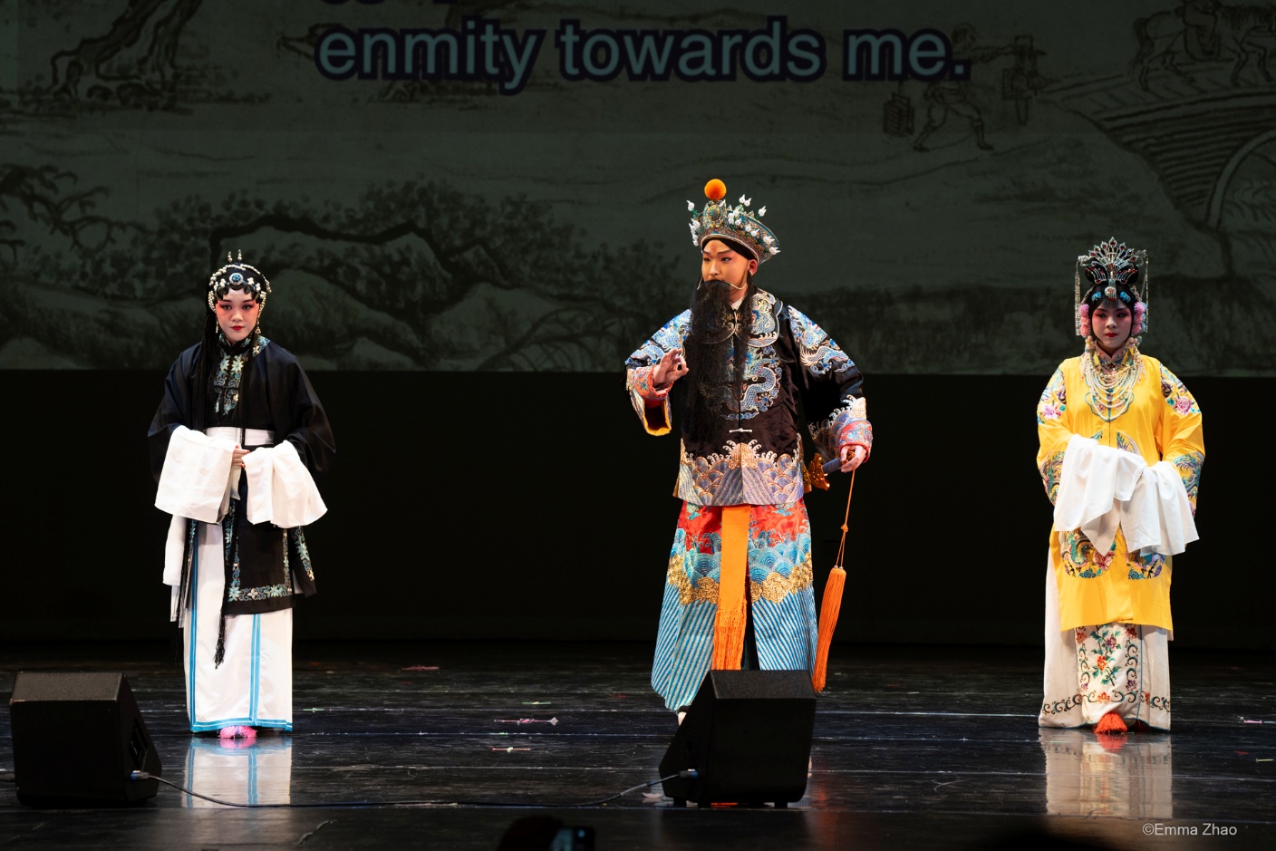 A group of people performing on a stage Description automatically generated