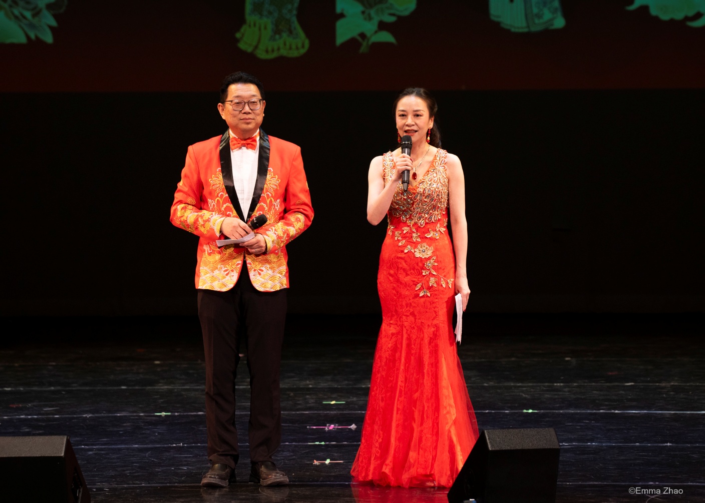 A person and person in formal attire on stage Description automatically generated